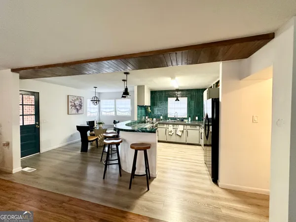 a view of a dining room with furniture and wooden floor