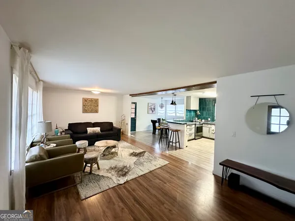 a living room with furniture and wooden floor