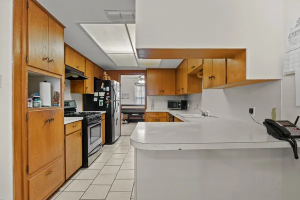 a kitchen with a sink stove and cabinets