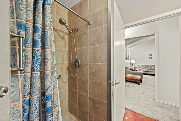 a bedroom with a bed and a ceiling fan