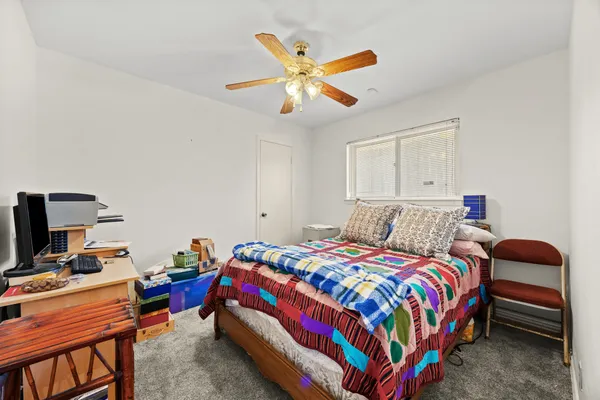 a bedroom with a bed and a chandelier