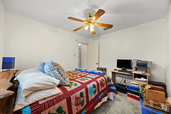 a bedroom with furniture and a chandelier
