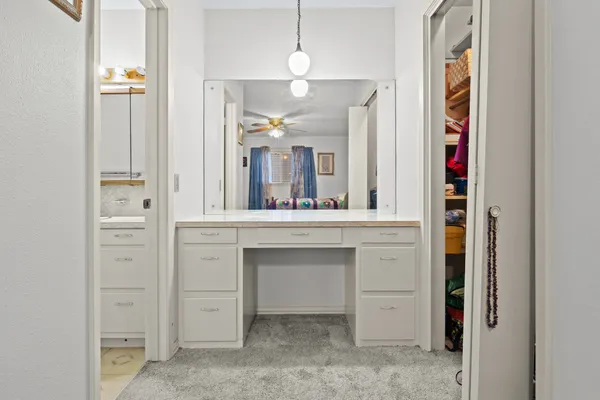 a bathroom with a granite countertop sink a toilet and a mirror