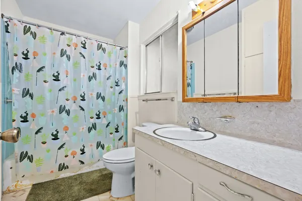 a bedroom with furniture and a large window