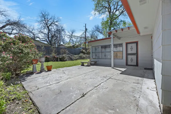 an aerial view of a house with a yard and trees