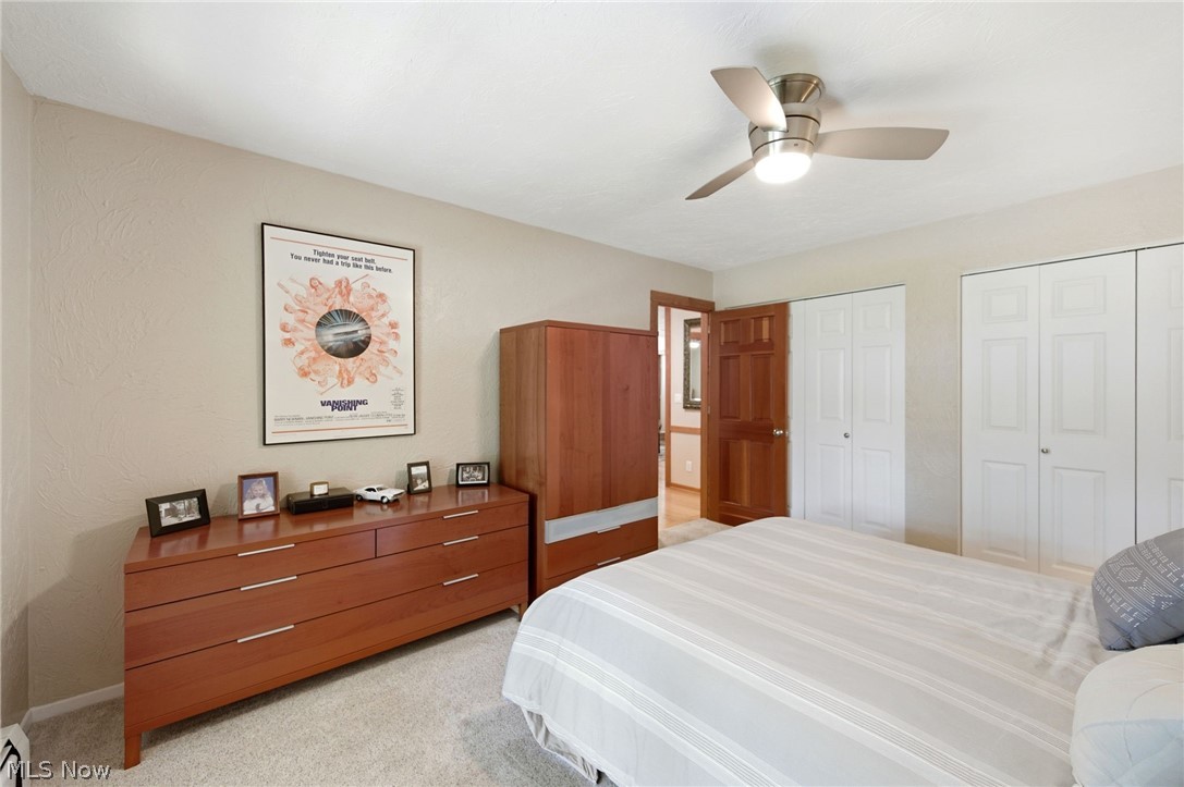 233 Sunset Road Avon Lake, OH 44012 - Photo 21 of 50 Carpeted room featuring a ceiling fan with integrated lighting, and two white bi-fold closet doors