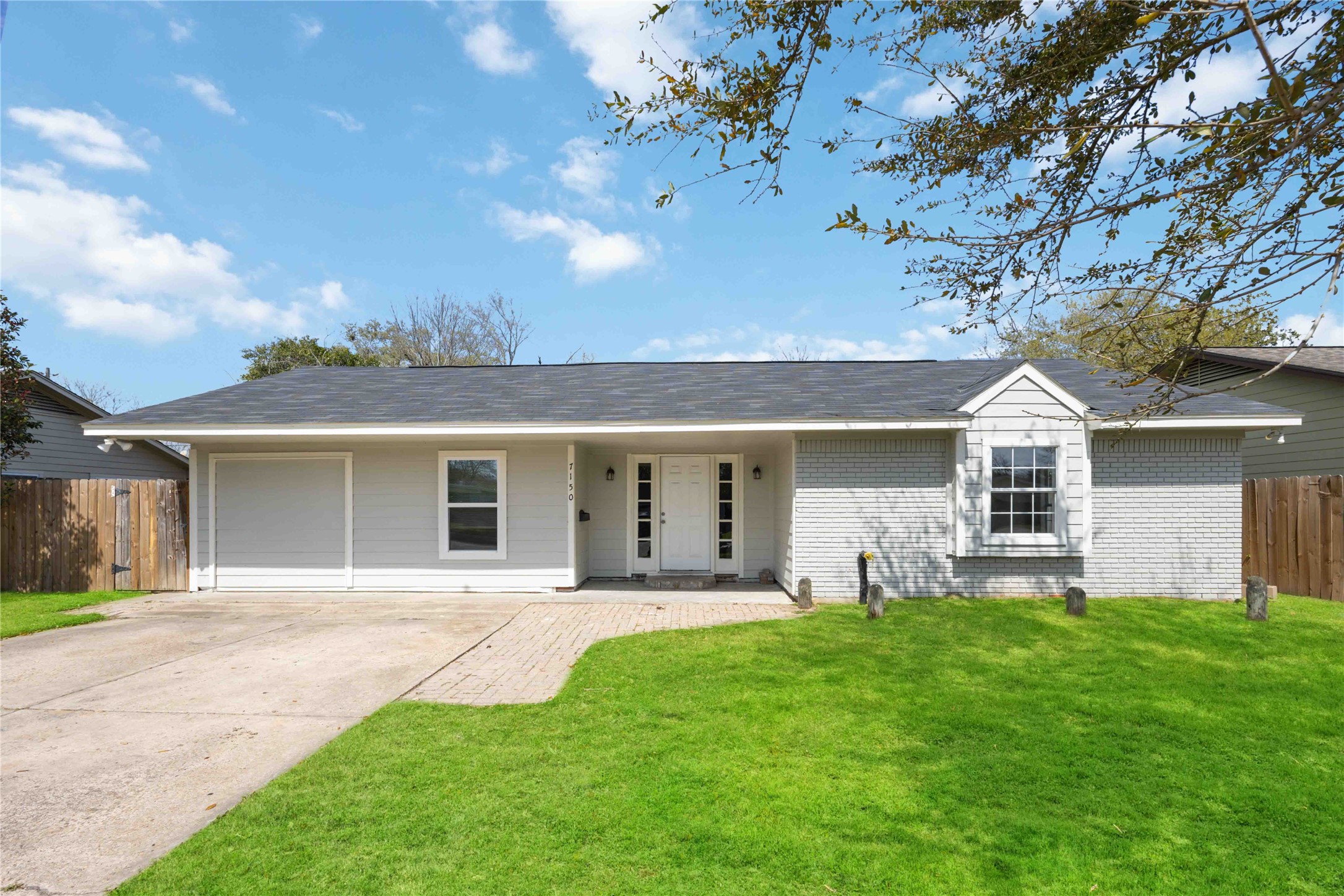 a front view of house with yard and green space