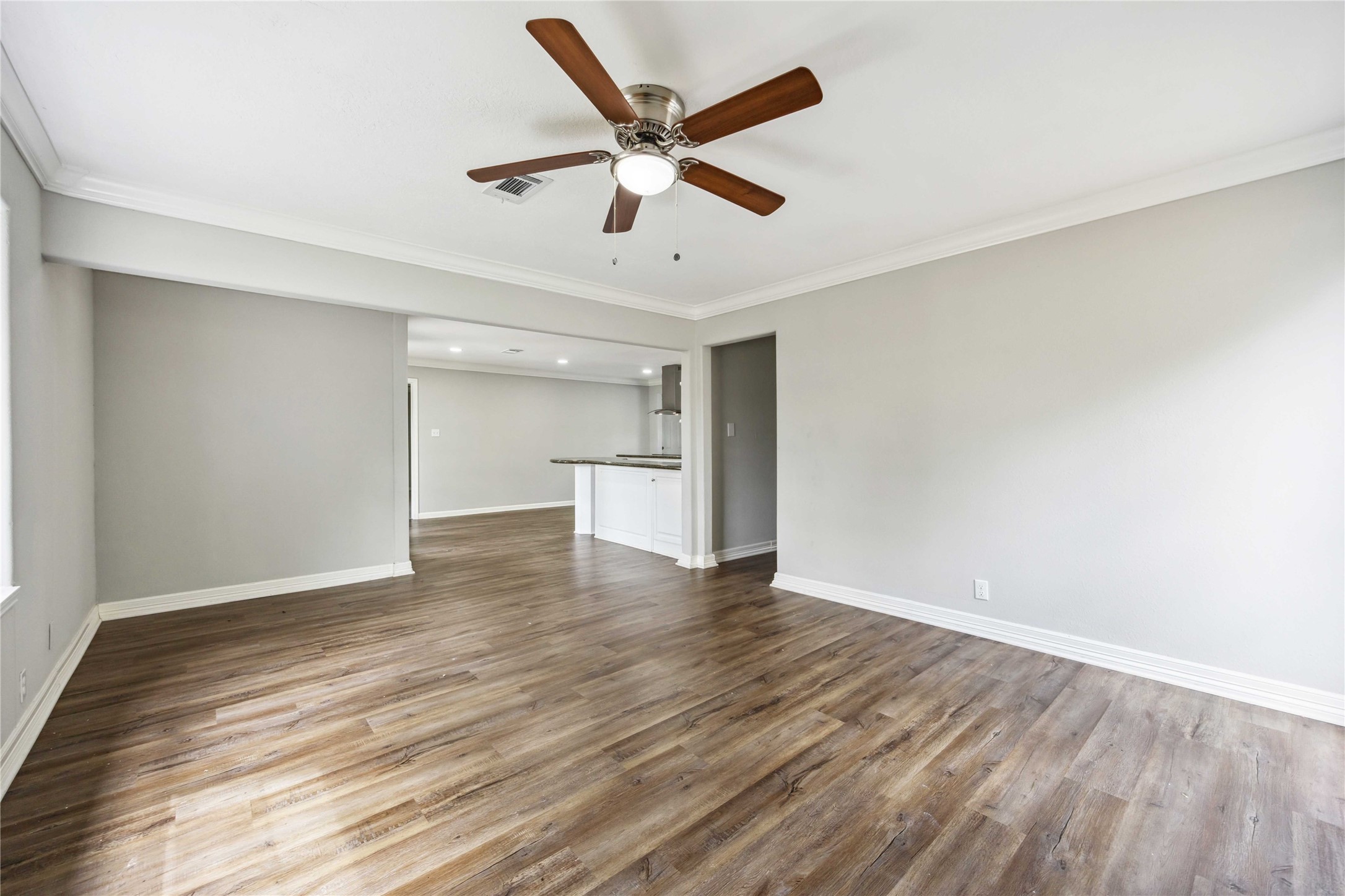 7150 Mobud Drive Houston, TX 77074 - Photo 29 of 29 a view of an empty room with wooden floor and a ceiling fan