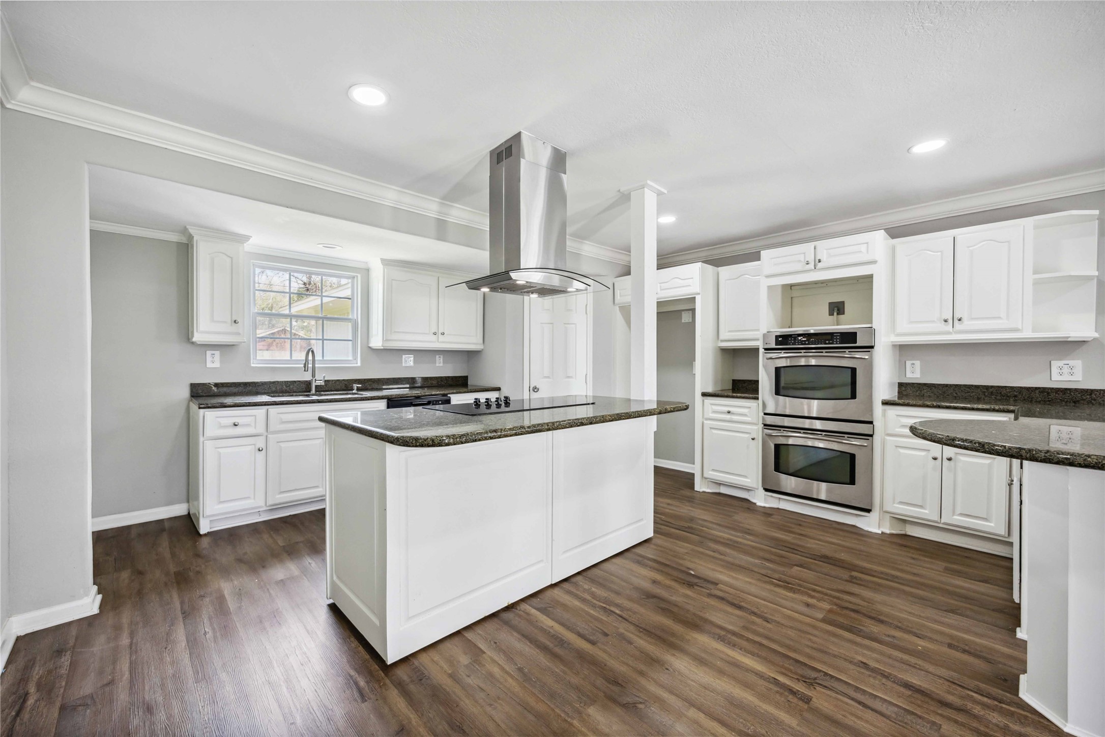 7150 Mobud Drive Houston, TX 77074 - Photo 5 of 29 a kitchen with stainless steel appliances a stove top oven and cabinets