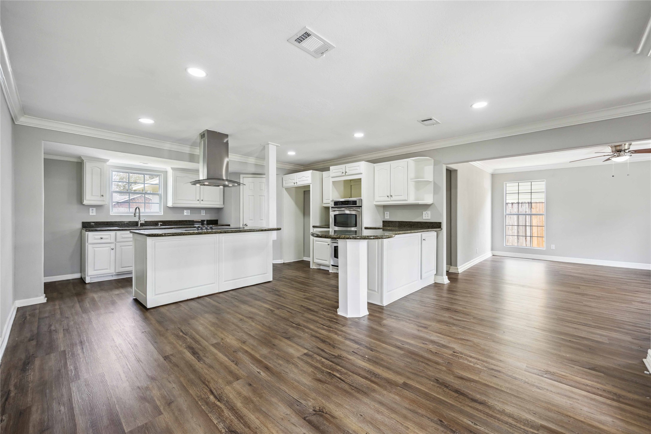 7150 Mobud Drive Houston, TX 77074 - Photo 28 of 29 a kitchen with stainless steel appliances kitchen island wooden floors and white cabinets