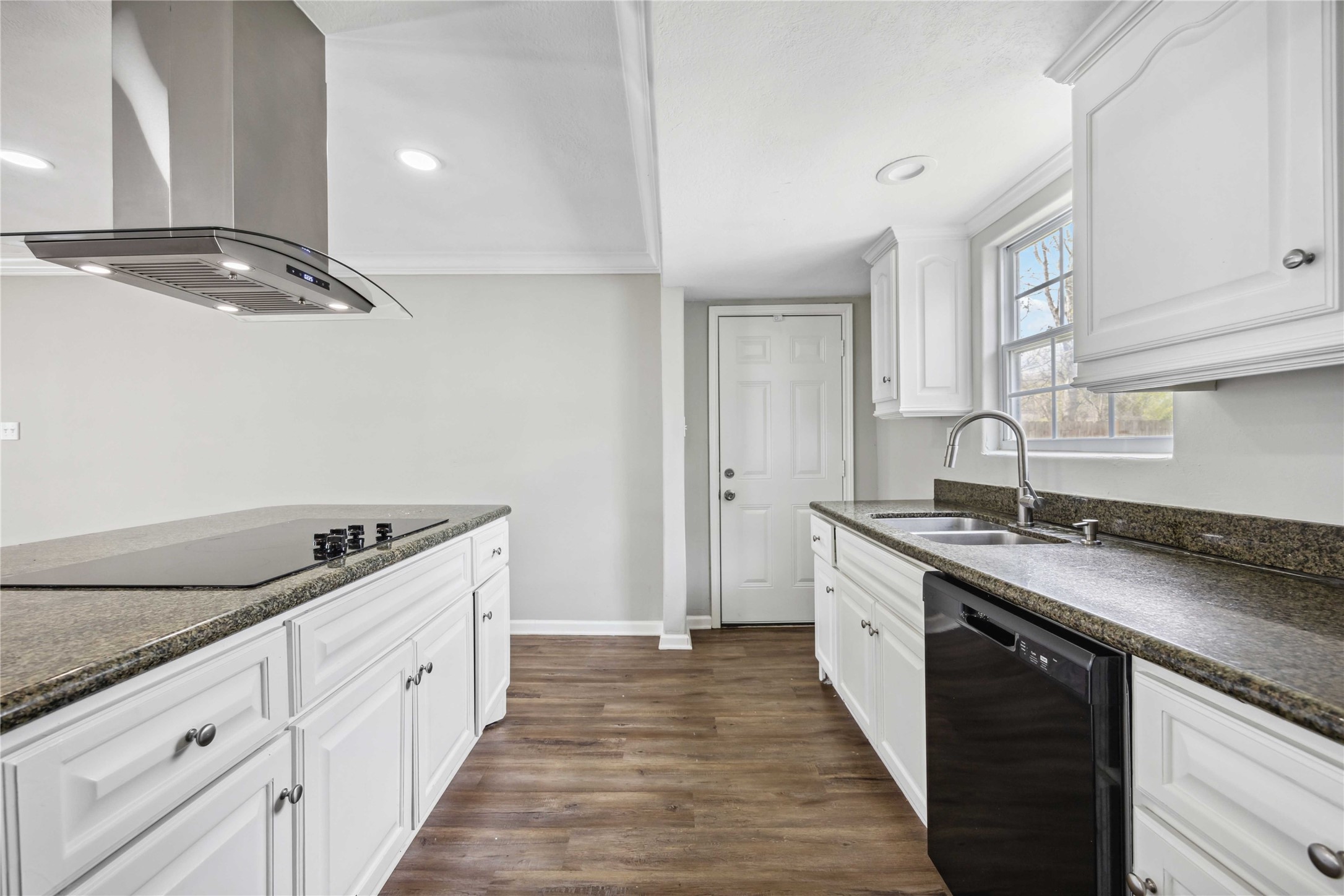 7150 Mobud Drive Houston, TX 77074 - Photo 7 of 29 a kitchen with granite countertop a sink and a stove top oven