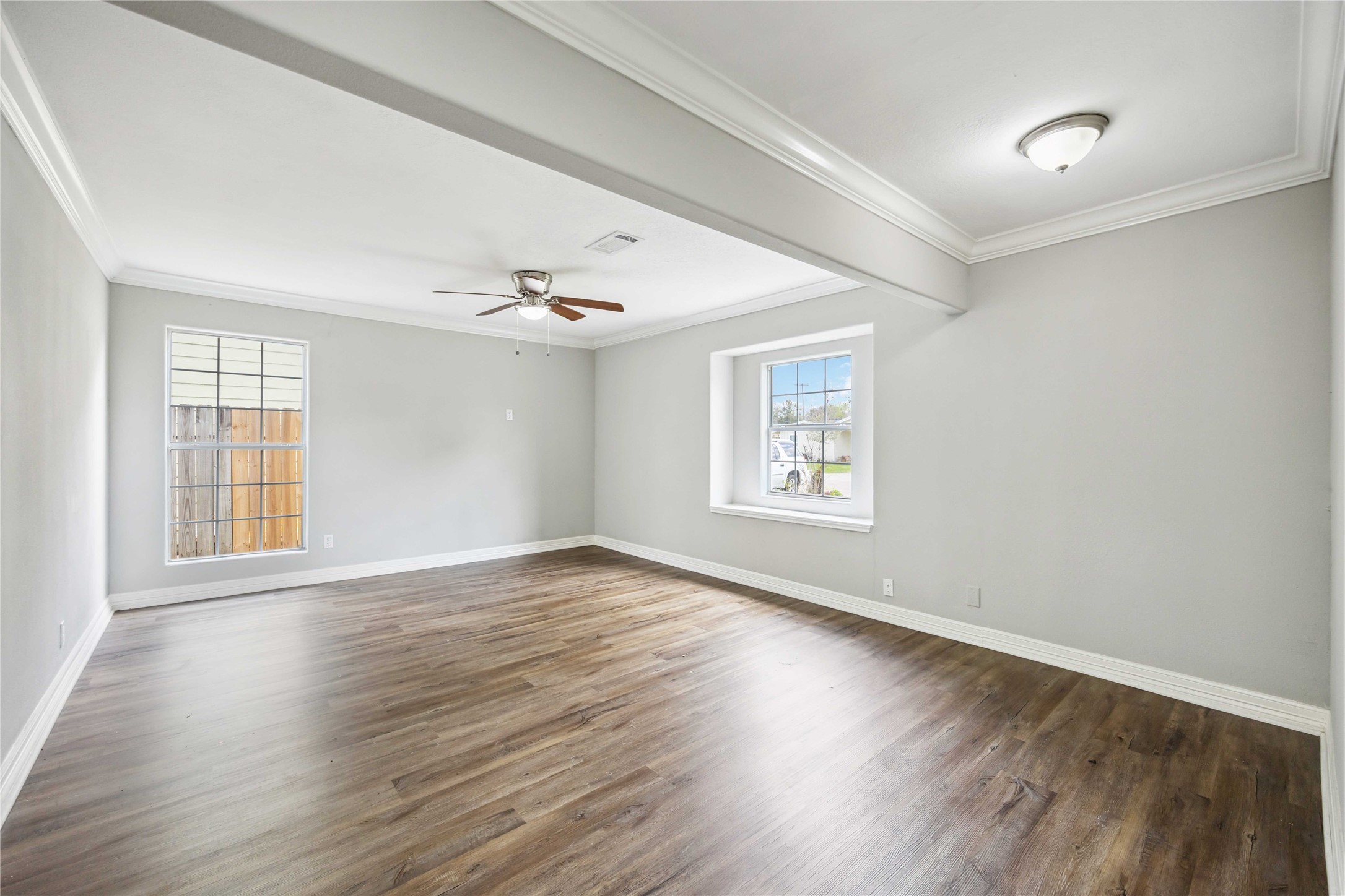 7150 Mobud Drive Houston, TX 77074 - Photo 9 of 29 an empty room with wooden floor chandelier and windows