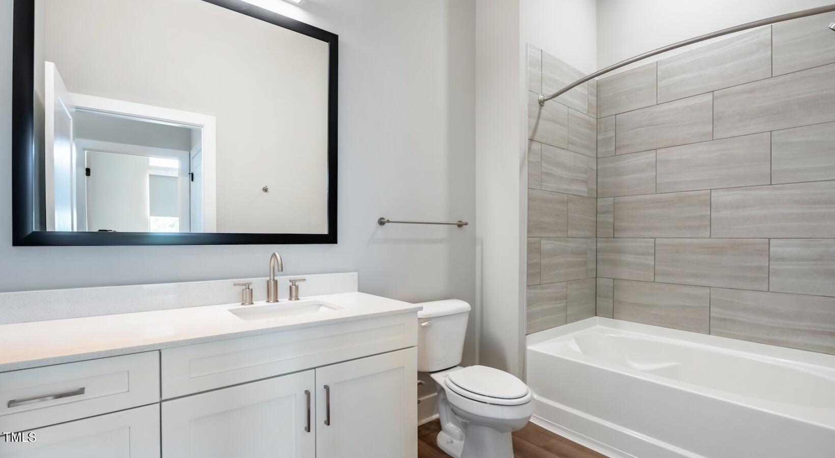 255 East Chatham Street, Unit A1 Cary, NC 27511 - Photo 13 of 31 a bathroom with a sink a toilet and a bathtub
