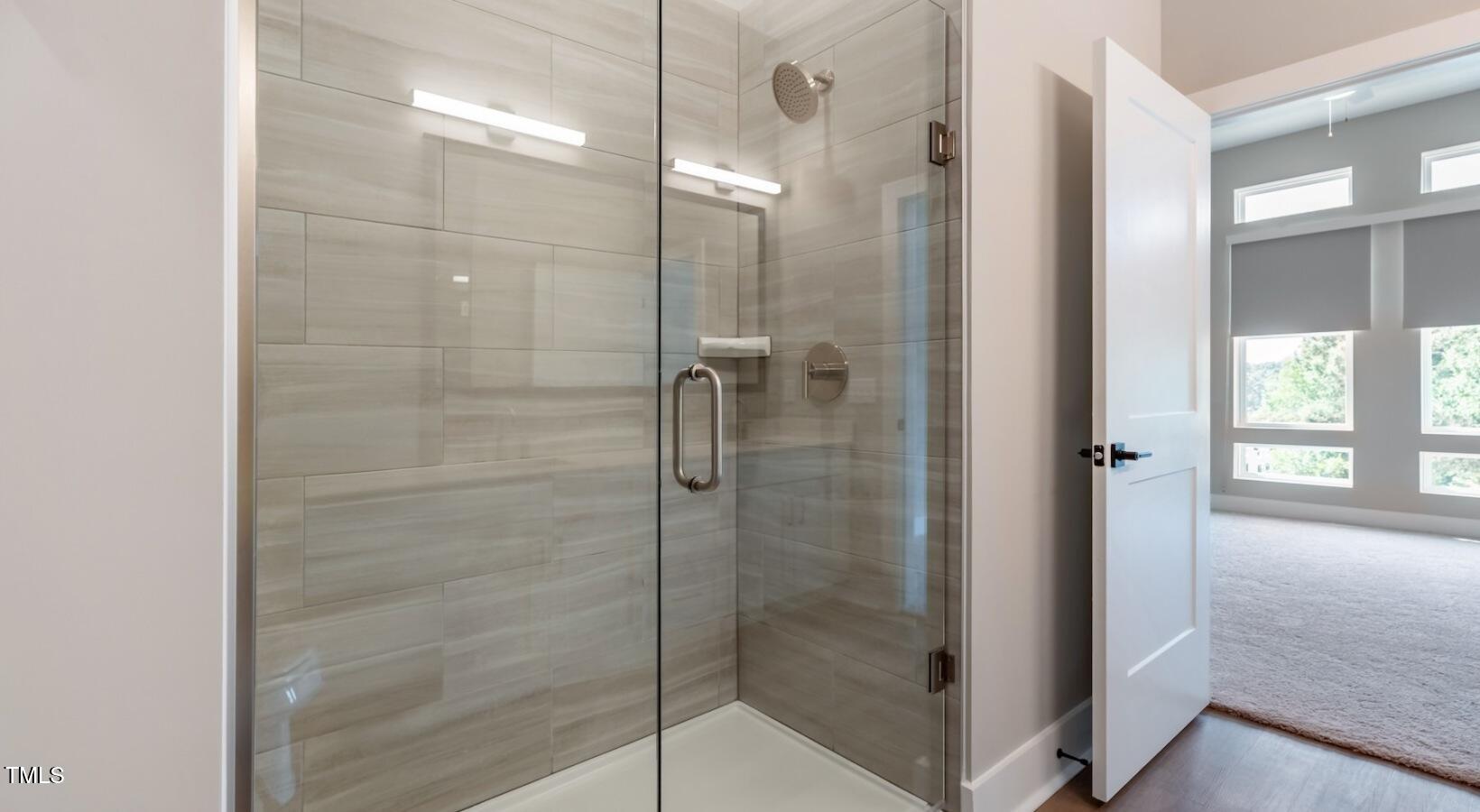 255 East Chatham Street, Unit A1 Cary, NC 27511 - Photo 15 of 31 a bathroom with a glass shower door