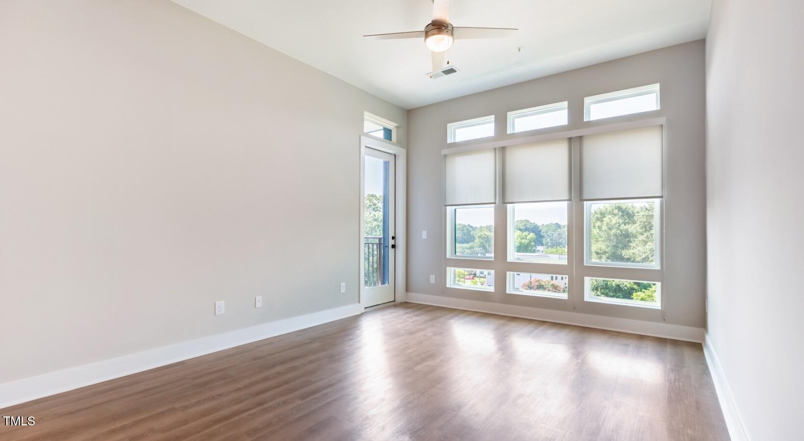 255 East Chatham Street, Unit A1 Cary, NC 27511 - Photo 18 of 31 an empty room with wooden floor and windows