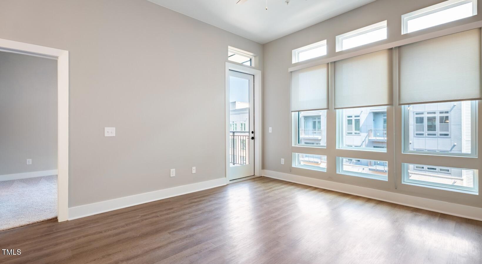 255 East Chatham Street, Unit A1 Cary, NC 27511 - Photo 25 of 31 wooden floor in an empty room with a window