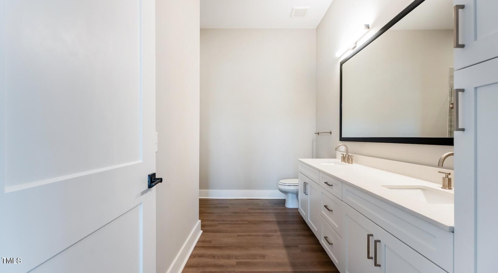 255 East Chatham Street, Unit A1 Cary, NC 27511 - Photo 26 of 31 a bathroom with a double vanity sink and mirror
