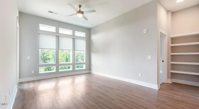 wooden floor in an empty room with a window