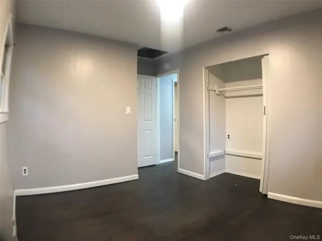 a view of an empty room and closet area