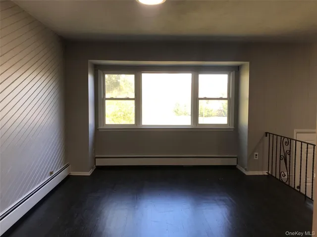 a view of a room with wooden floor and windows