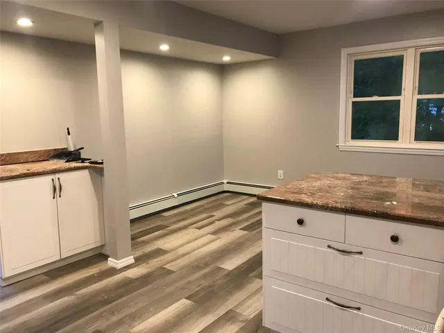 a view of kitchen with granite countertop cabinets appliances and a window