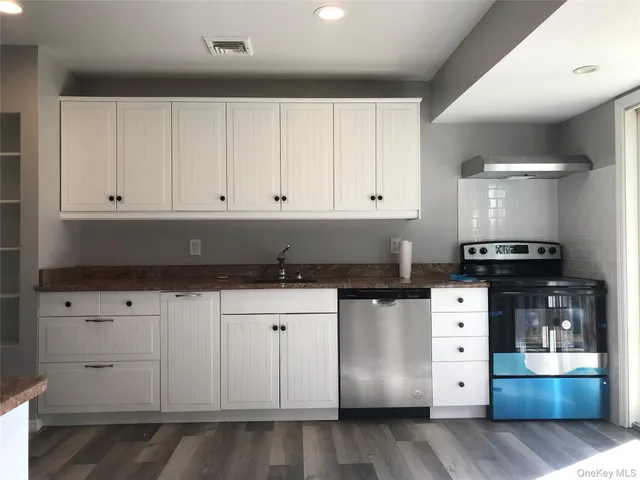 a kitchen with cabinets appliances and a counter space