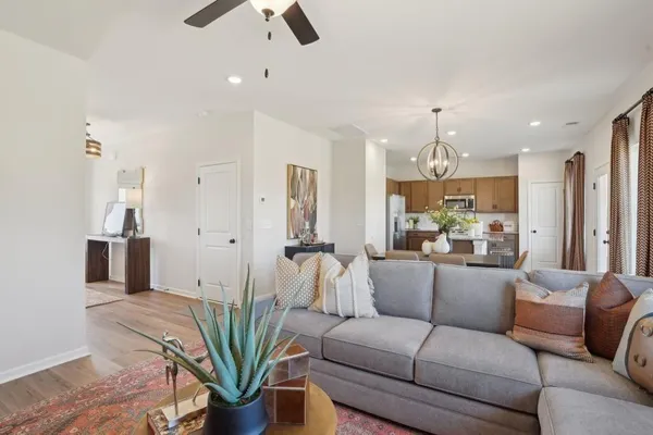 a view of kitchen with kitchen island wooden floors appliances and cabinets