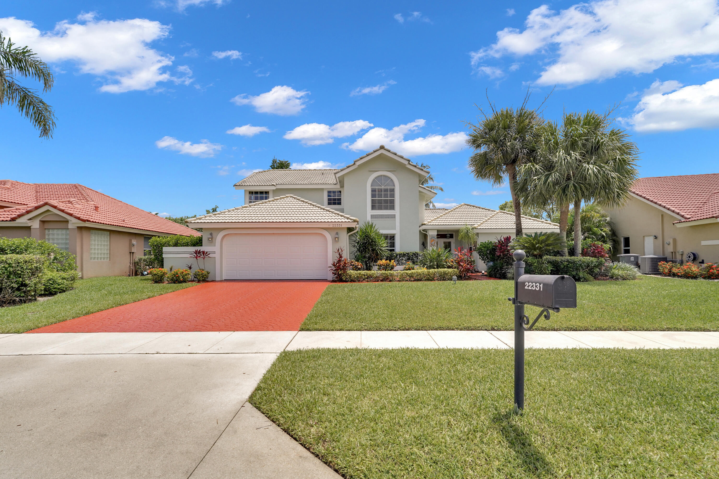 22331 Kettle Creek Way Boca Raton, FL 33428 - Photo 2 of 86 a front view of a house with a yard and garage