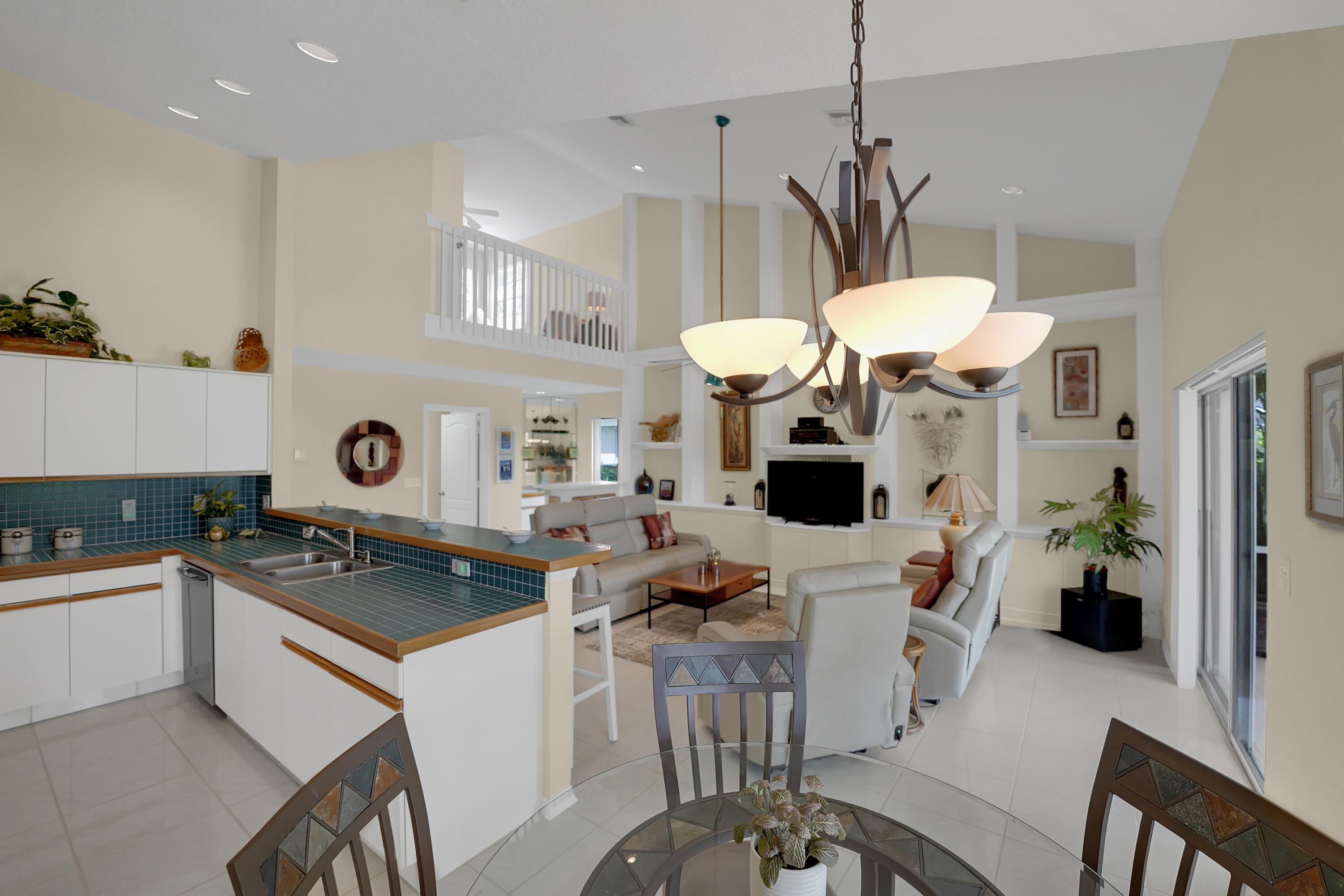 22331 Kettle Creek Way Boca Raton, FL 33428 - Photo 21 of 86 a kitchen with stainless steel appliances a stove a sink a dining table and chairs