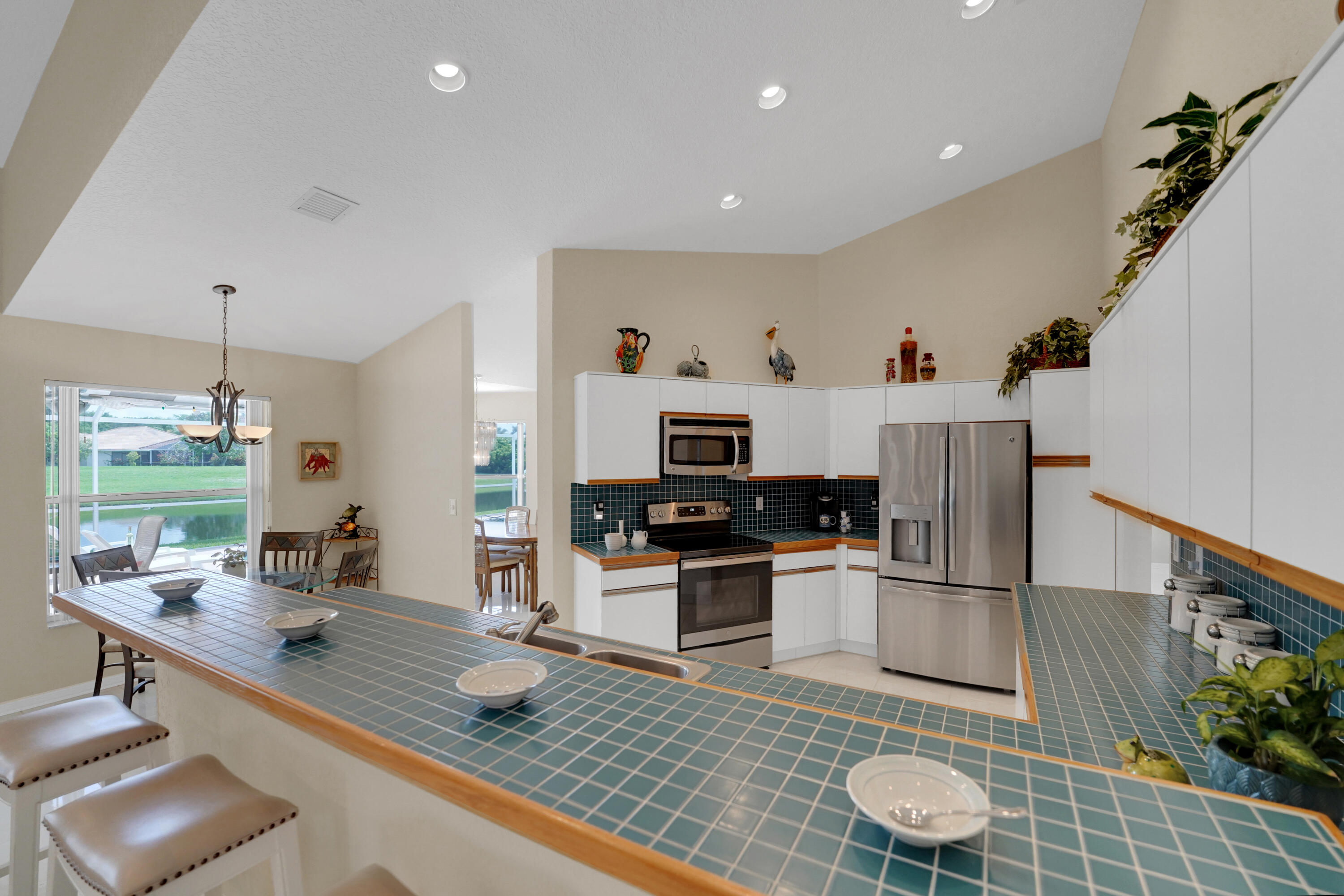 22331 Kettle Creek Way Boca Raton, FL 33428 - Photo 25 of 86 a kitchen with sink refrigerator and stove