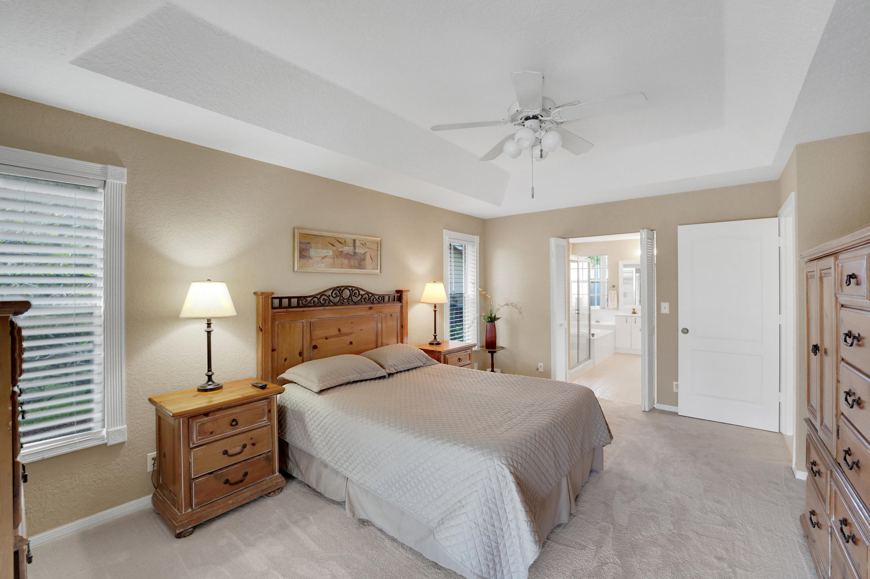 22331 Kettle Creek Way Boca Raton, FL 33428 - Photo 40 of 86 a spacious bedroom with a bed and a chandelier
