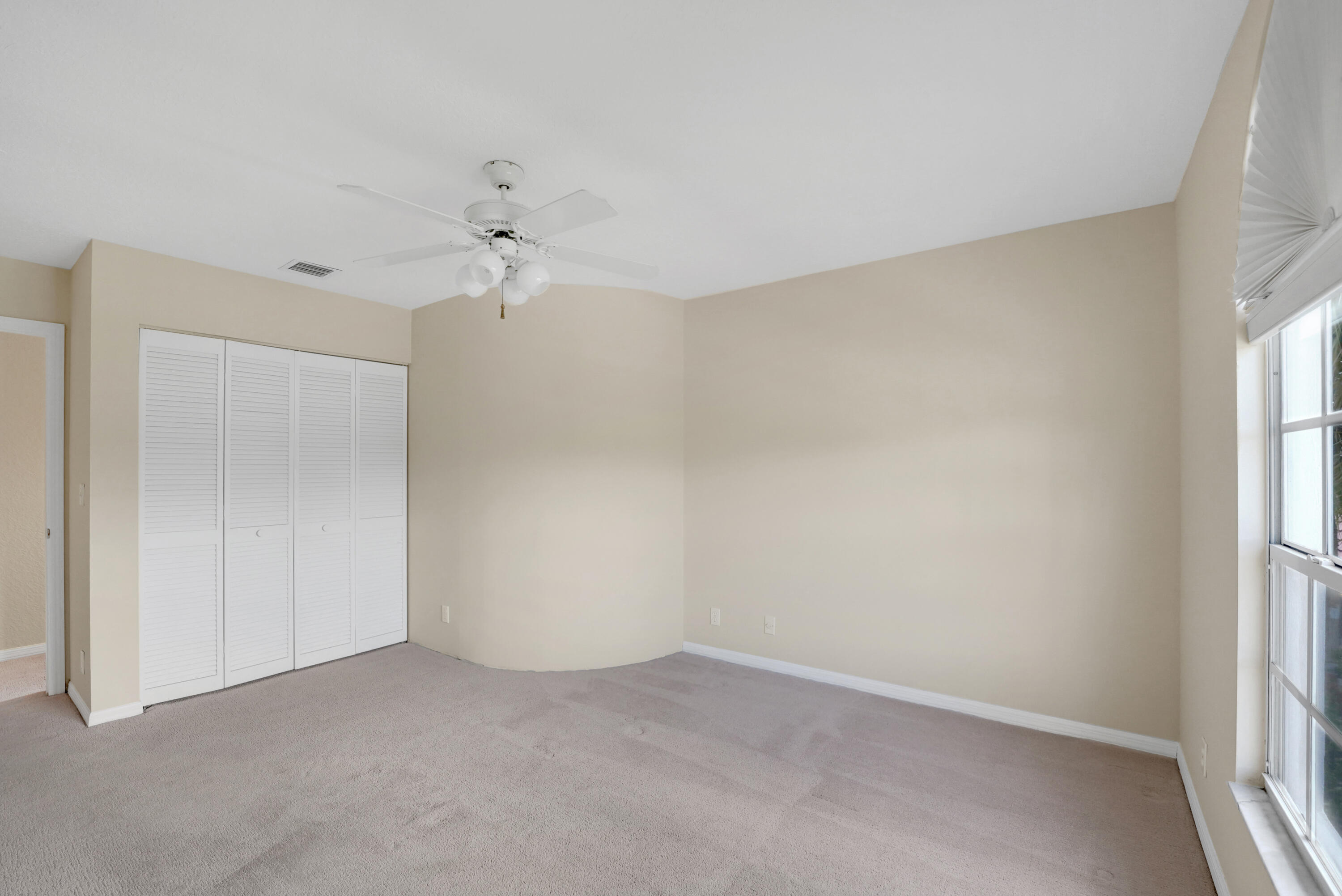 22331 Kettle Creek Way Boca Raton, FL 33428 - Photo 53 of 86 an empty room with a window and a ceiling fan