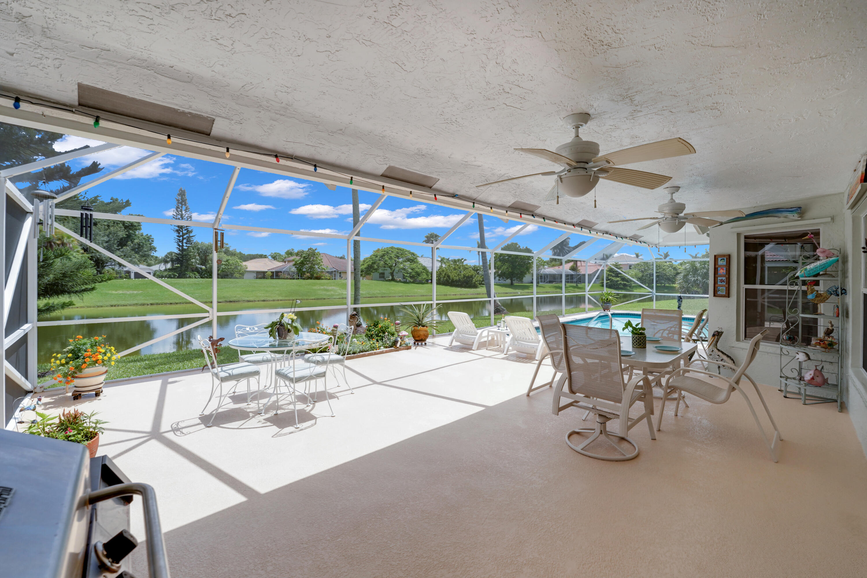 22331 Kettle Creek Way Boca Raton, FL 33428 - Photo 60 of 86 a view of a patio with a table chairs and a backyard
