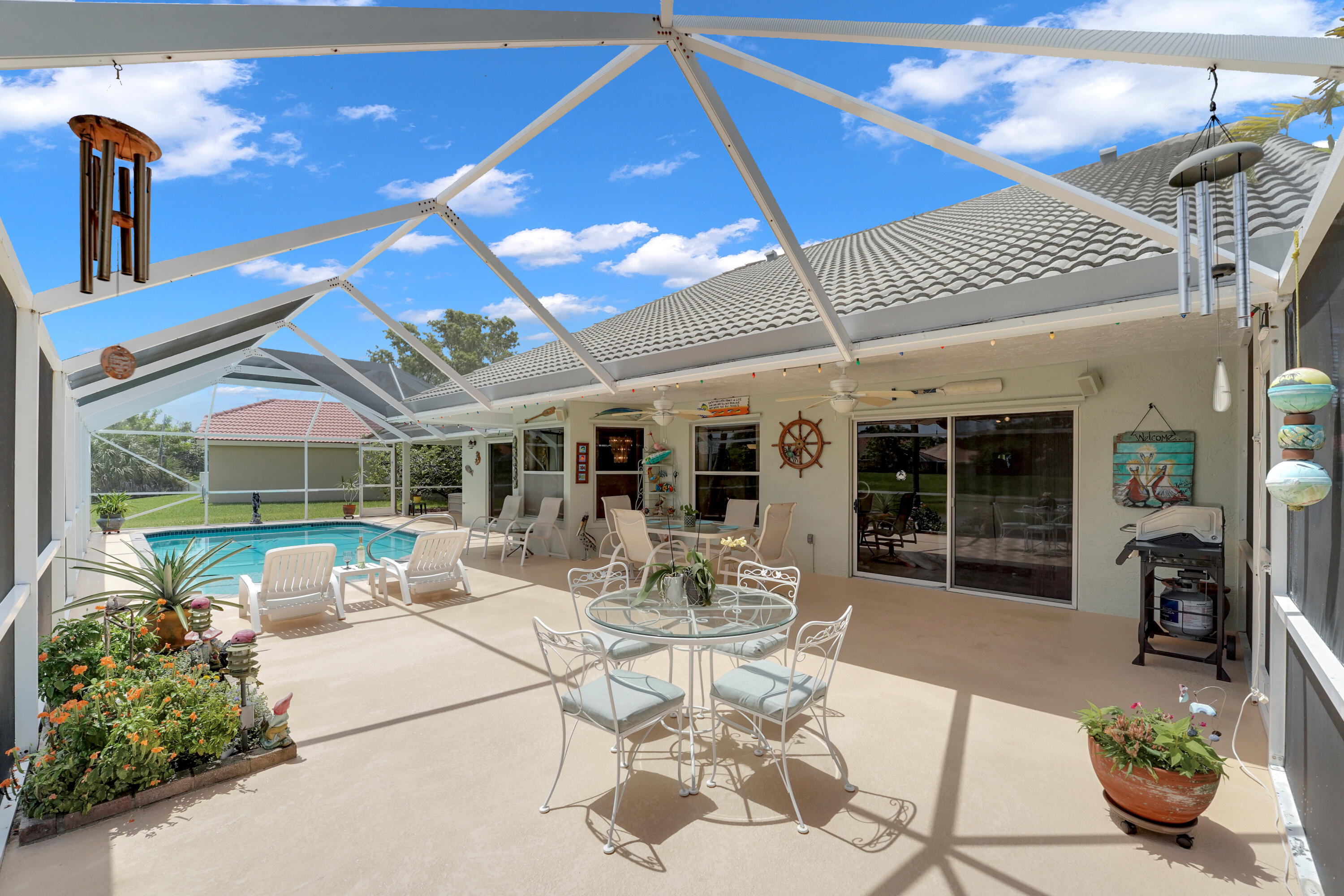 22331 Kettle Creek Way Boca Raton, FL 33428 - Photo 62 of 86 a view of a patio with table and chairs potted plants with floor to ceiling window and potted plants