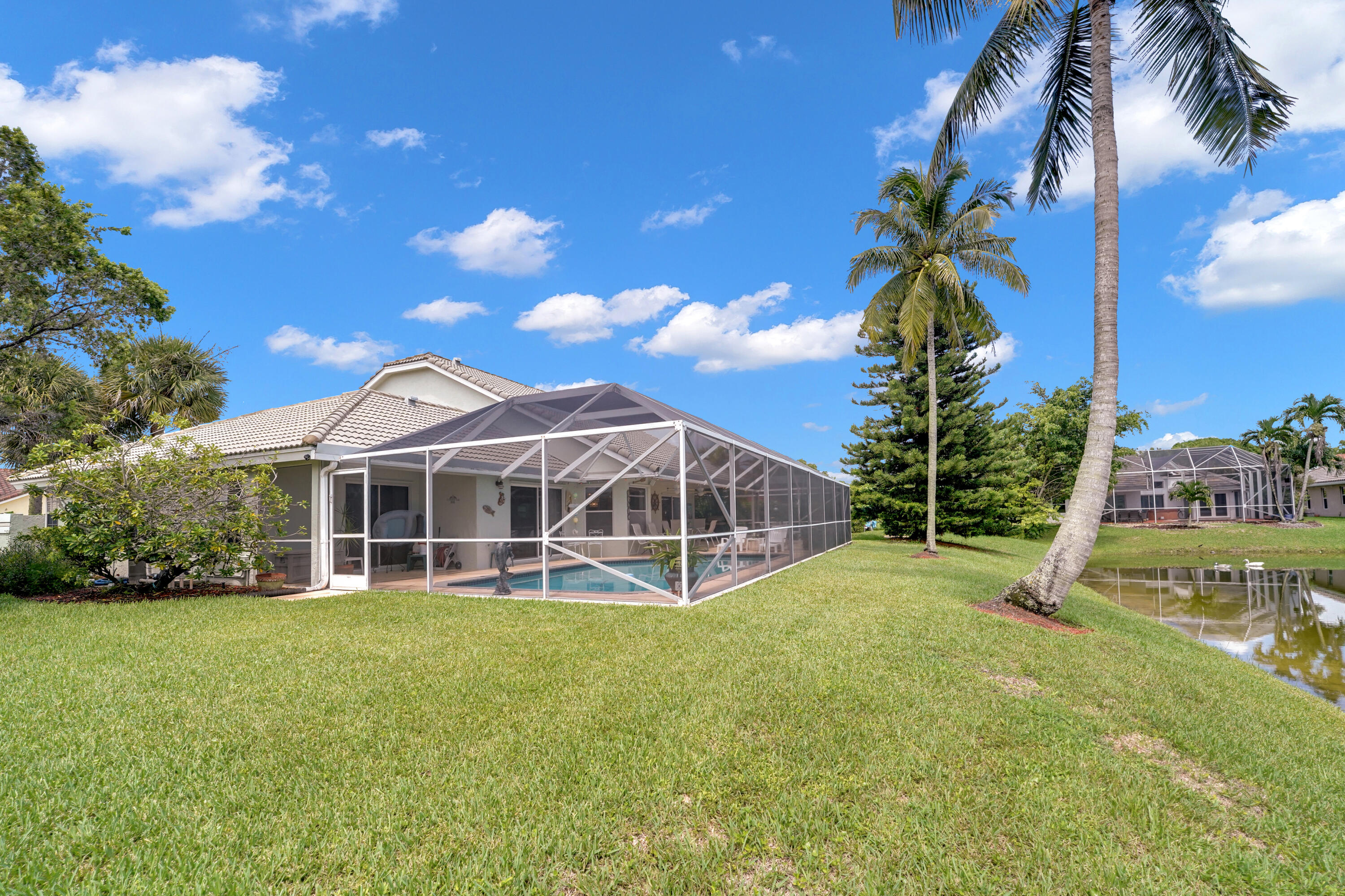 22331 Kettle Creek Way Boca Raton, FL 33428 - Photo 66 of 86 a view of a house with a yard and palm trees