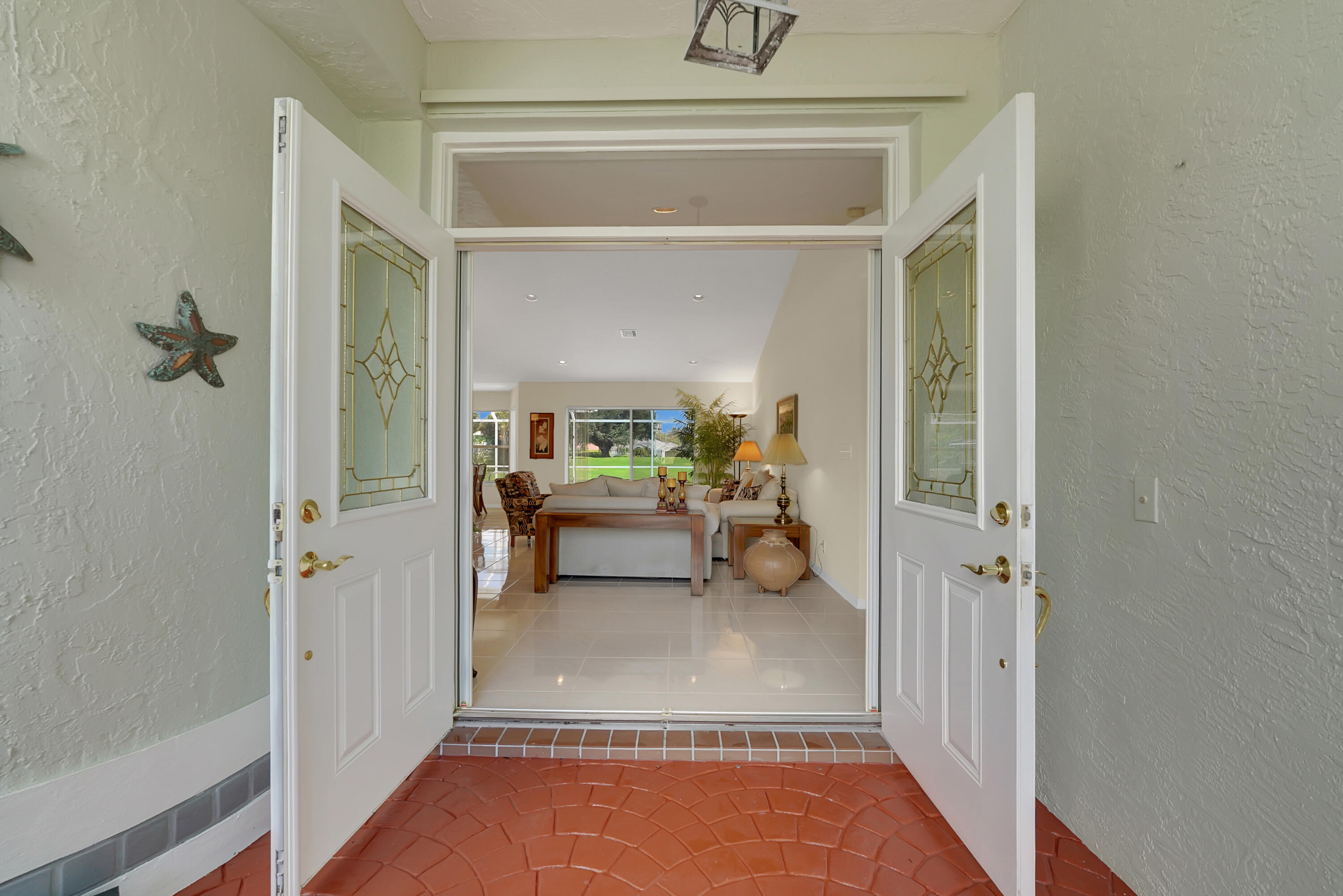 22331 Kettle Creek Way Boca Raton, FL 33428 - Photo 7 of 86 a view of a hallway to a livingroom and a livingroom with furniture