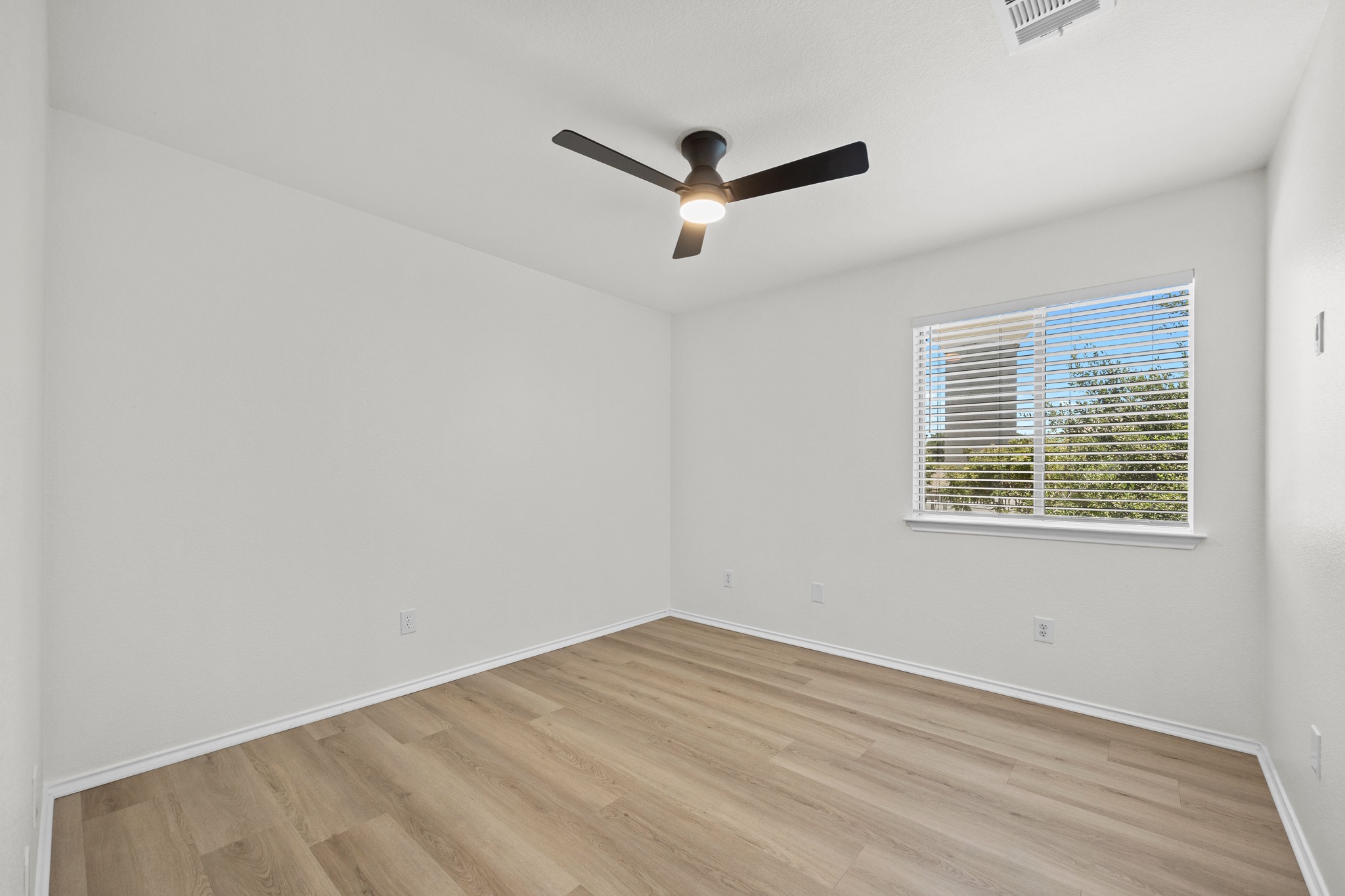 1818 Lost Maples Loop Cedar Park, TX 78613 - Photo 22 of 38 A quiet retreat with durable plank flooring, illuminated by natural light and overhead fan.