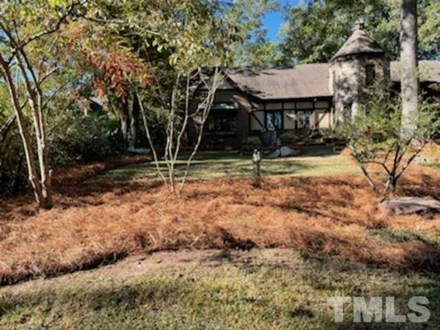 1164 Keith Hills Road Lillington, NC 27546 - Photo 19 of 47 a house with trees in front of it