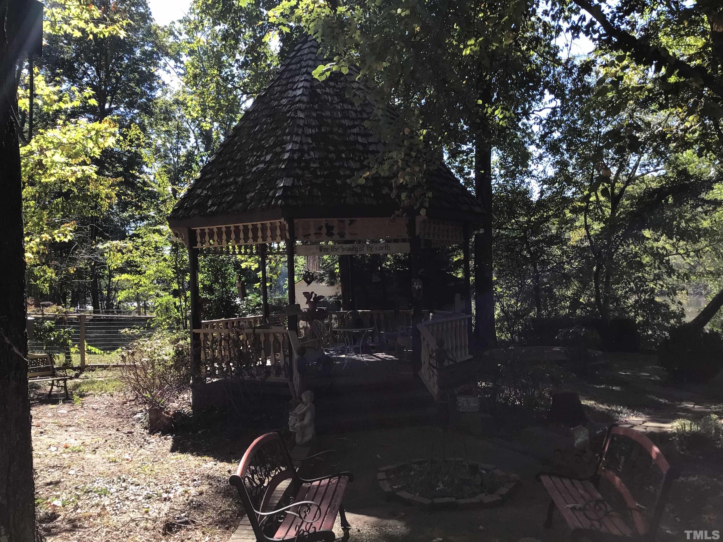 1164 Keith Hills Road Lillington, NC 27546 - Photo 7 of 47 a patio with table and chairs and potted plants