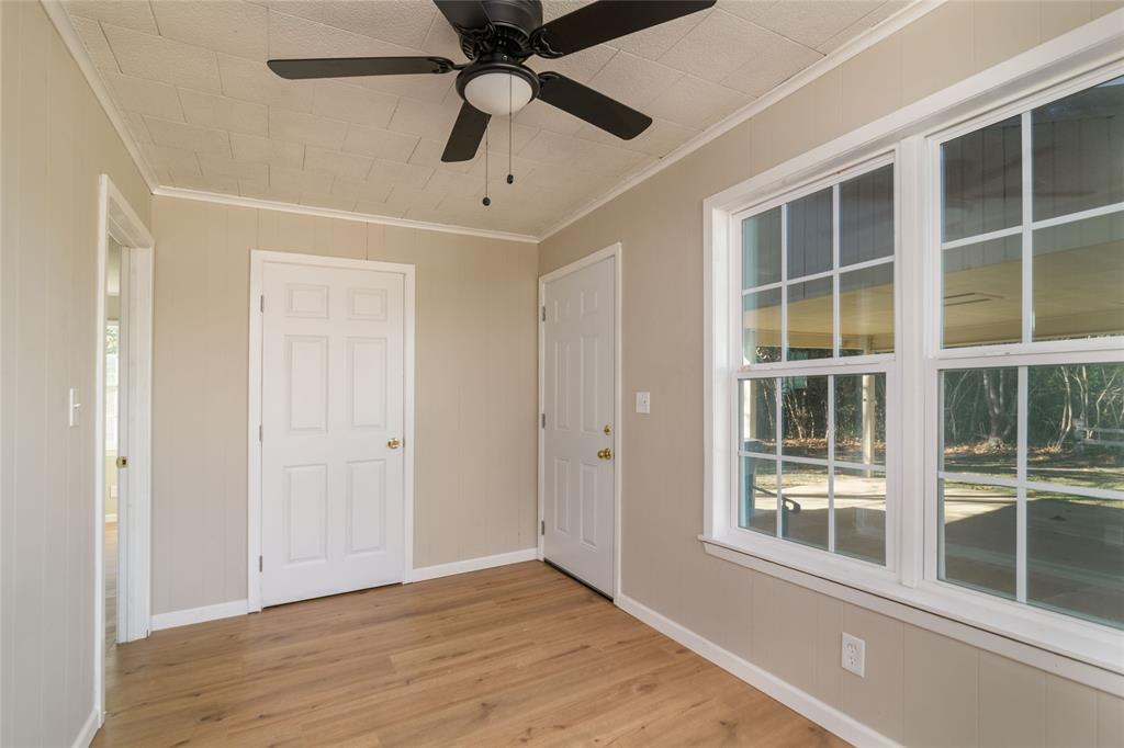 1456 Cooper Street Saline, LA 71070 - Photo 14 of 24 a view of an empty room with a window and wooden floor