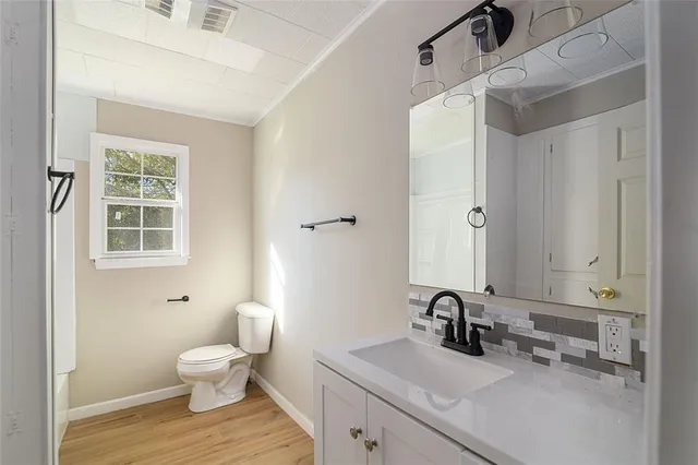 a bathroom with a sink toilet and a mirror