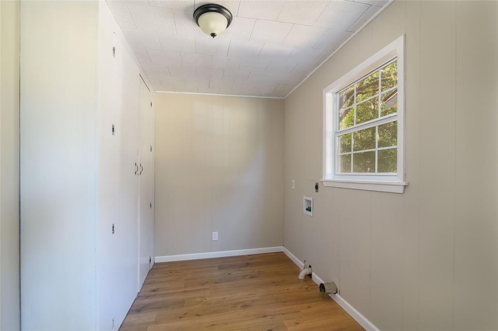 1456 Cooper Street Saline, LA 71070 - Photo 22 of 24 an empty room with wooden floor and windows