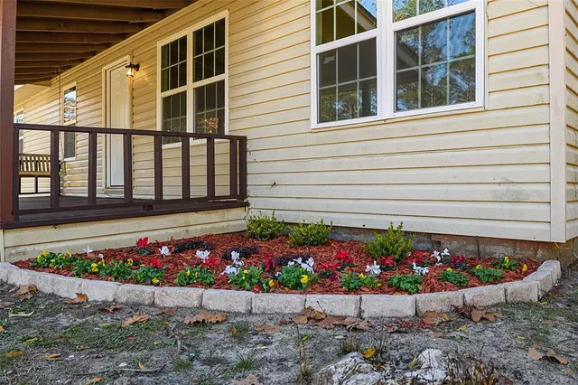 a bunch of flowers in front of the house