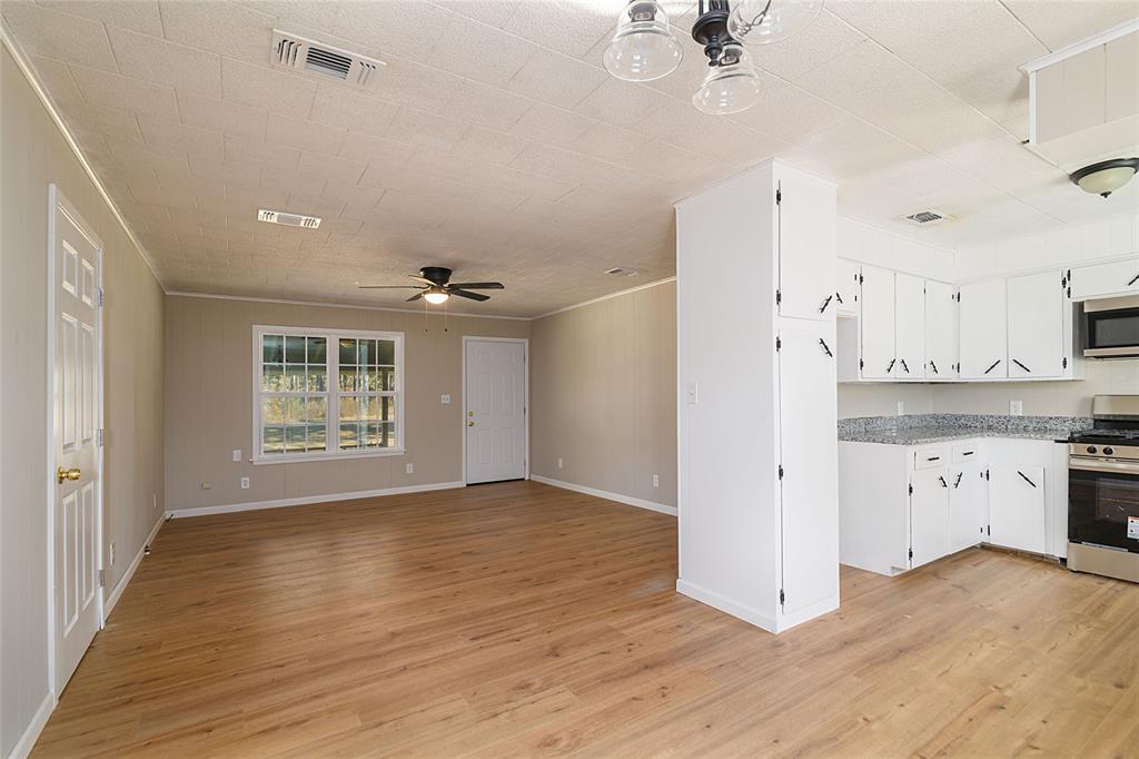 1456 Cooper Street Saline, LA 71070 - Photo 5 of 24 a view of a kitchen with a sink and a refrigerator
