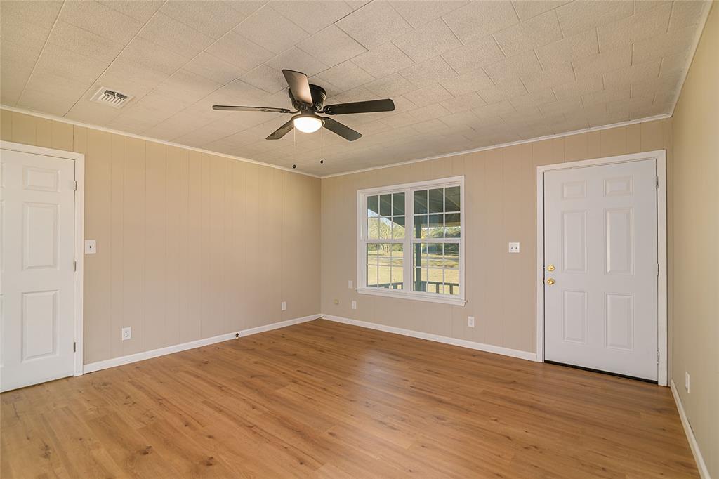 1456 Cooper Street Saline, LA 71070 - Photo 7 of 24 a view of empty room with wooden floor and fan