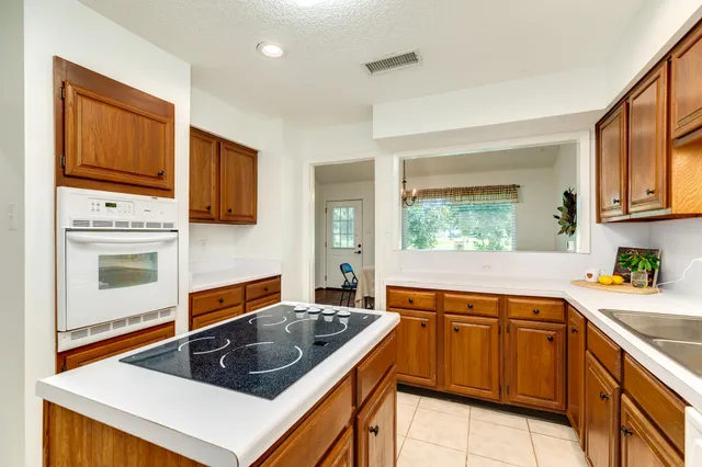 a kitchen with stainless steel appliances a stove sink and cabinets