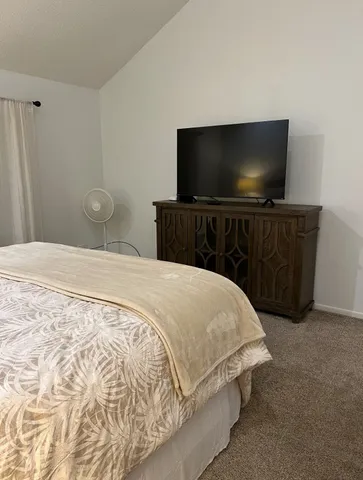 a bedroom with a bed and a flat screen tv