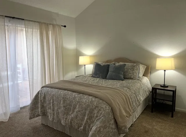 a bedroom with a bed and a lamp