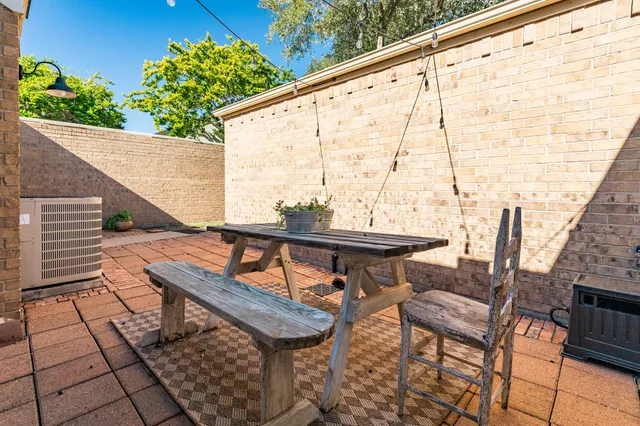 a roof deck with table and chairs and wooden floor