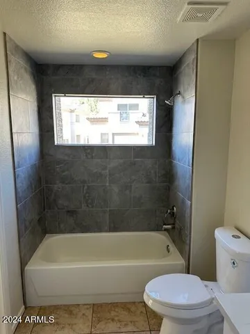 a bathroom with a toilet a sink and bathtub